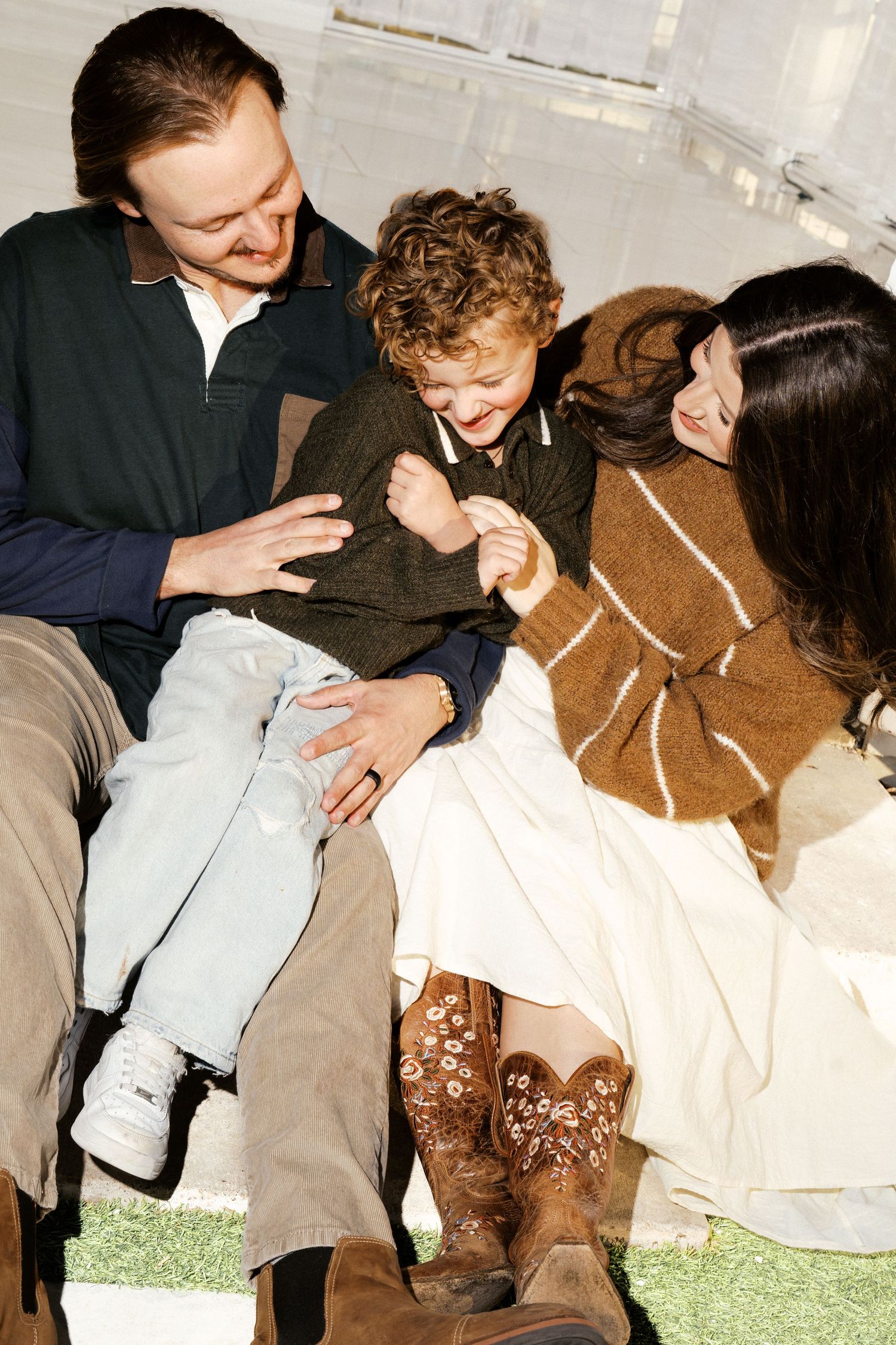 A series of photos showing people gathered closely together on grass, appearing to be in an intimate social setting.