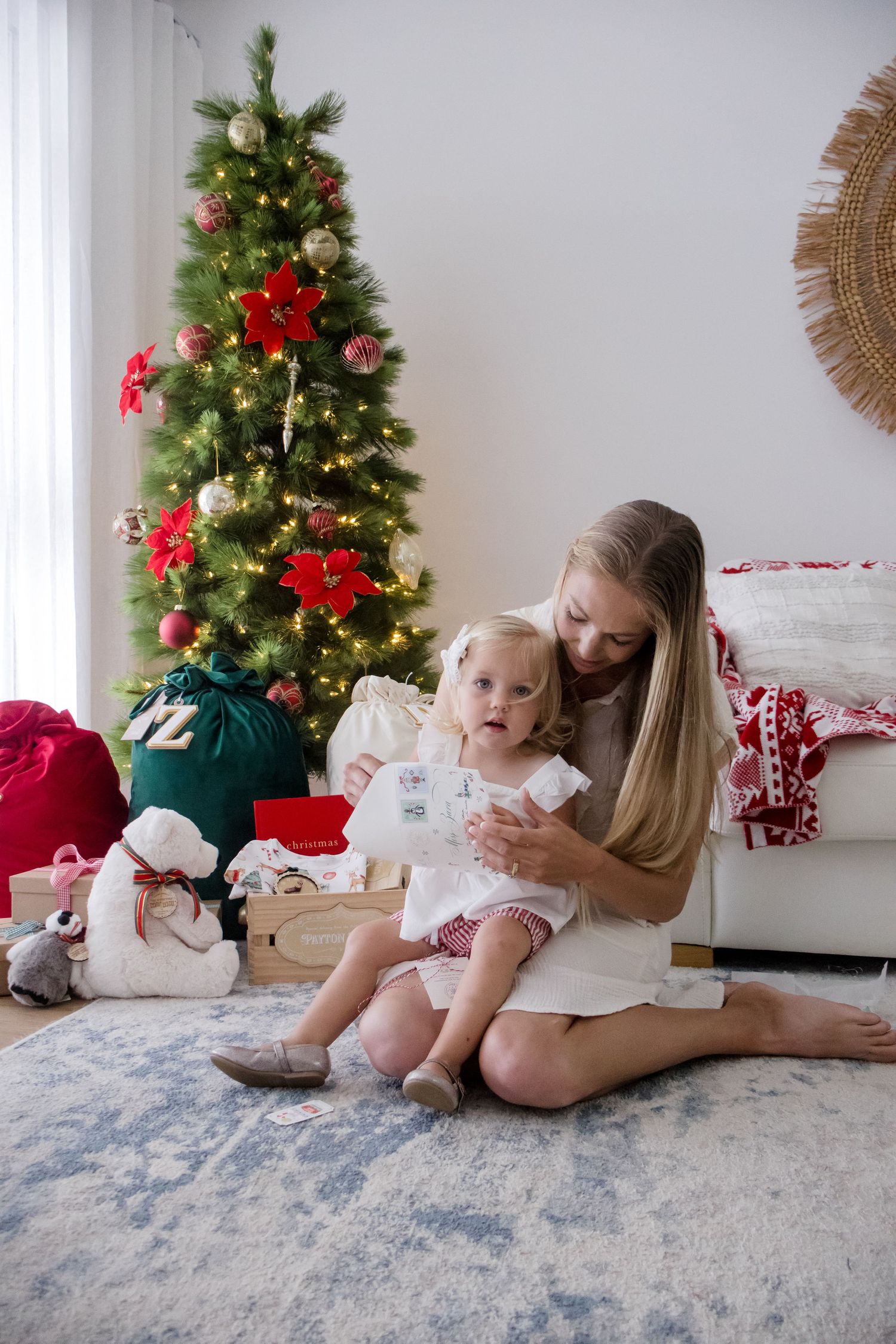 Cozy Christmas scene with decorated tree, white walls, and plush carpet creating a warm holiday atmosphere.
