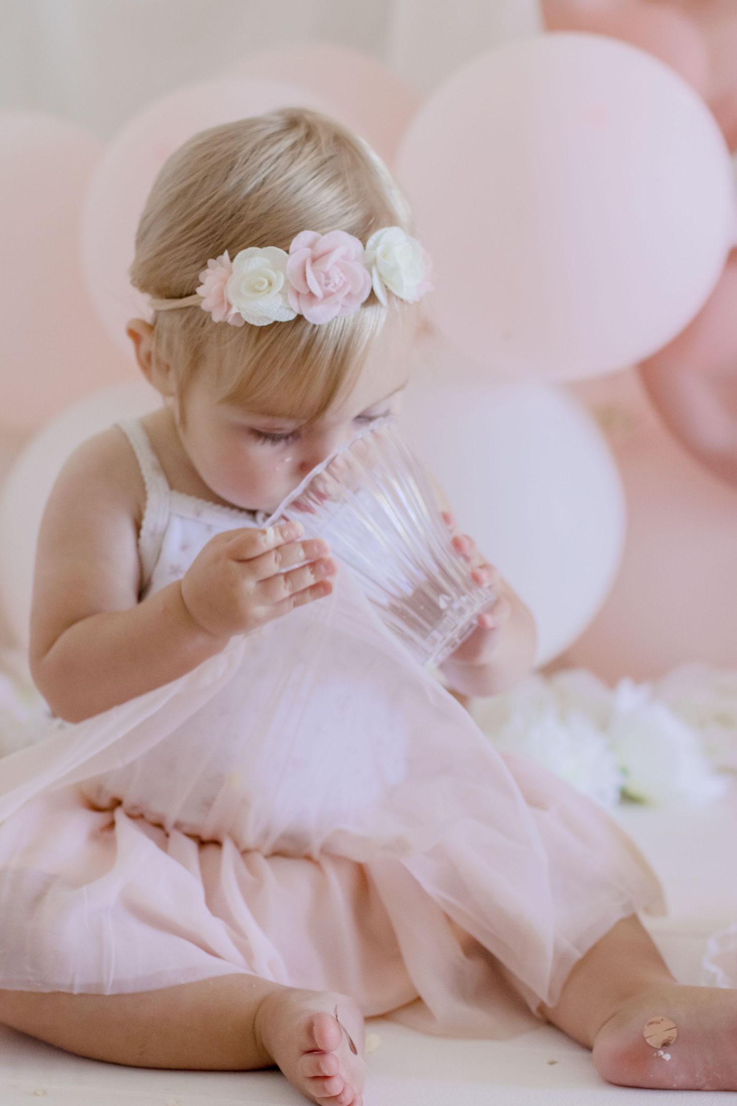 Delicate moment captured in pink tulle dress with floral headpiece.