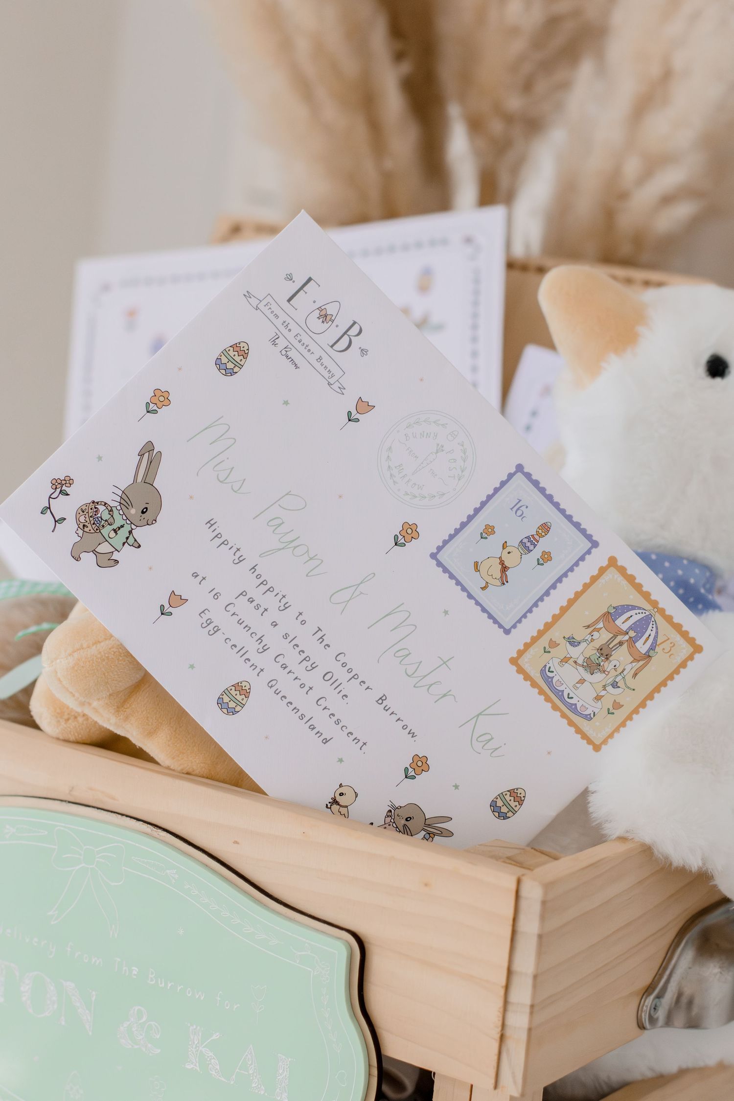 Easter gift box with bunny invitation cards, plush toy, and mint tin for children named Mason and Kai.