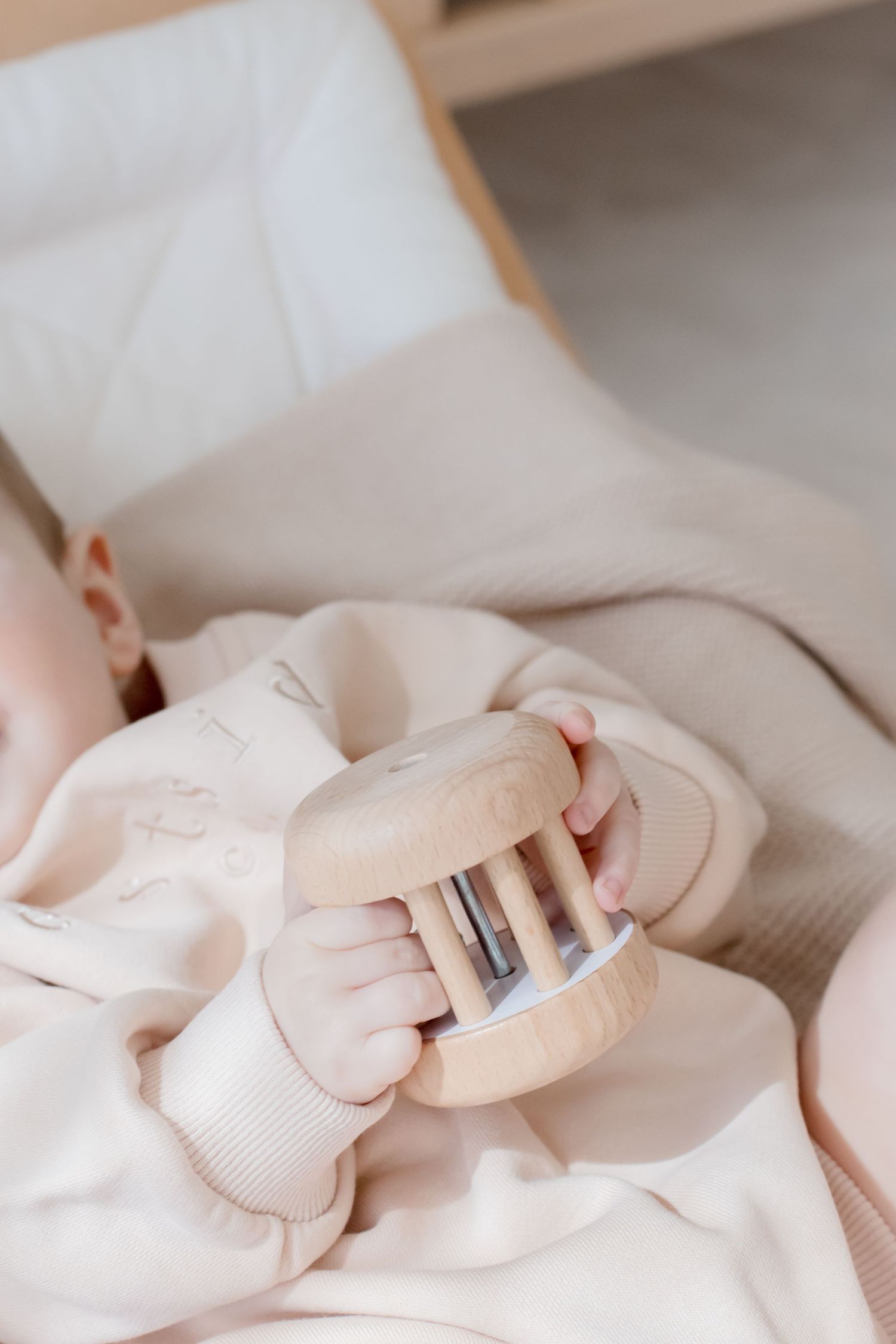 Close-up of soft pink baby accessories and clothing details.