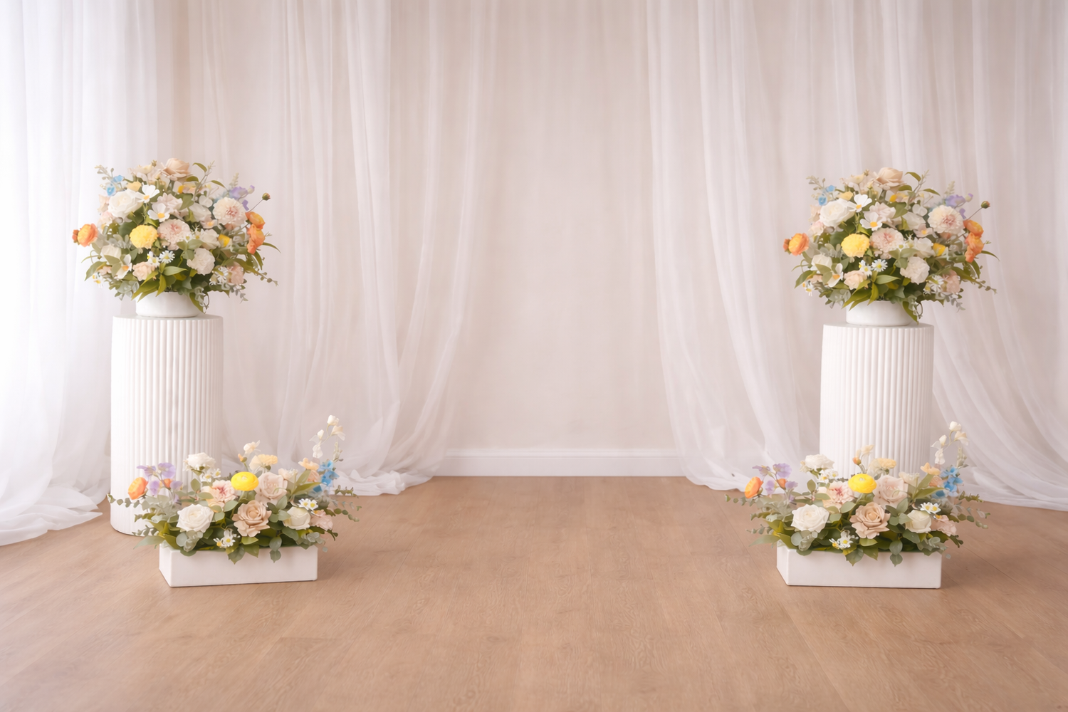 Elegant wedding backdrop with white columns adorned with pastel floral arrangements against a light curtained background.