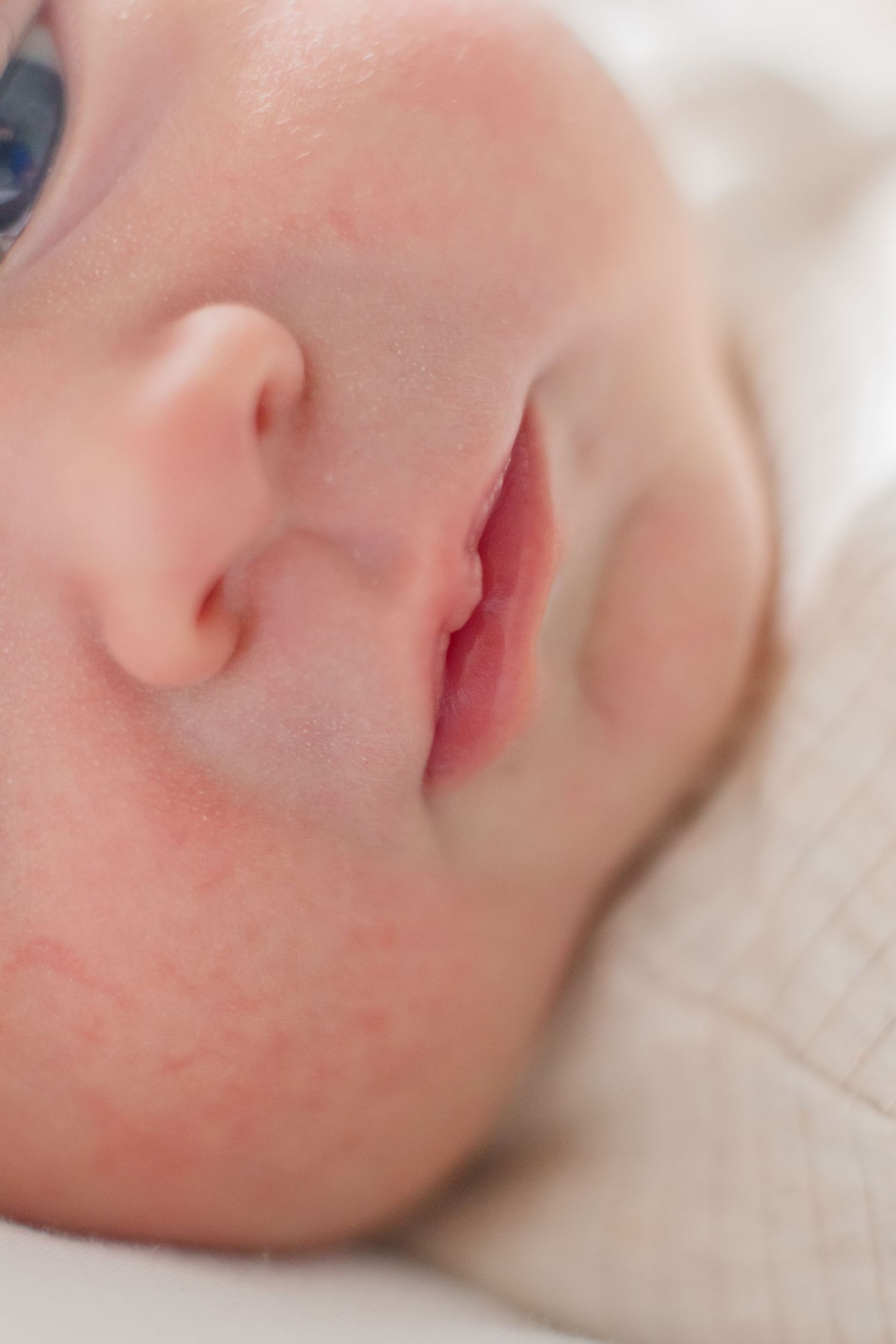 Extreme close-up of baby's nose and mouth showing delicate facial features.