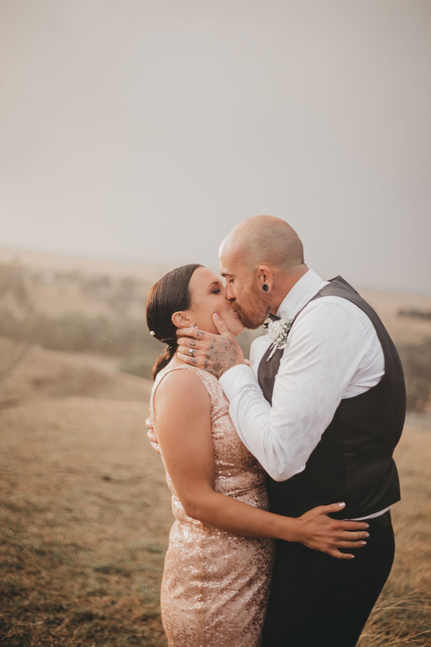 A romantic couple shares tender kisses in a sequence of photos against a dreamy desert landscape background.