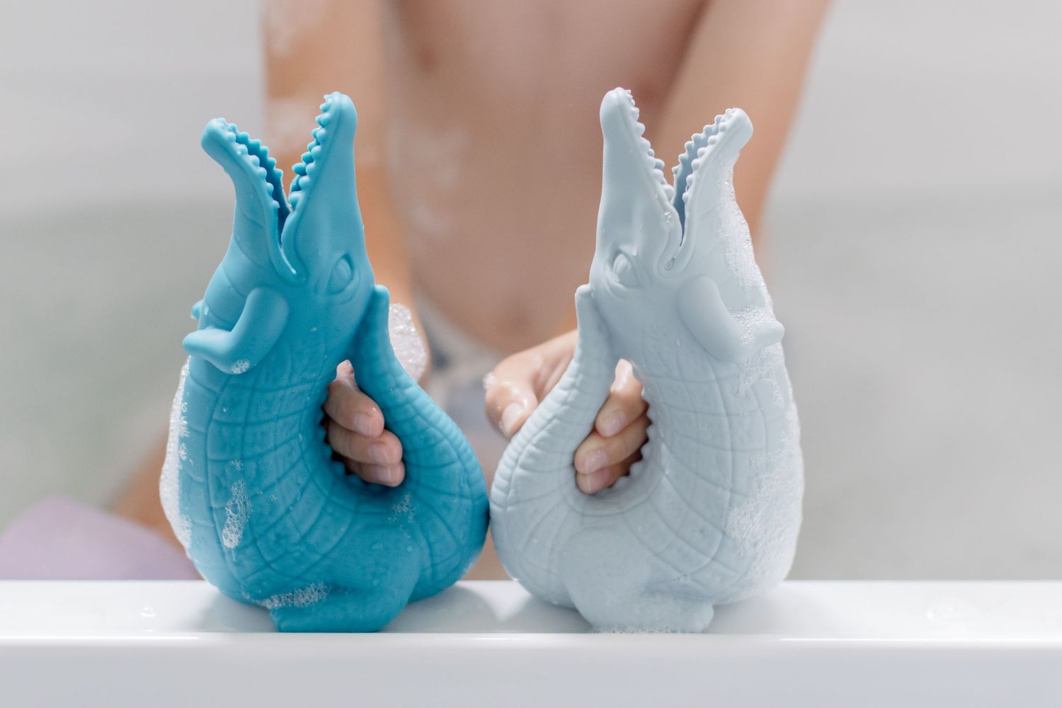 Two decorative ceramic whale figures in blue and gray colors.