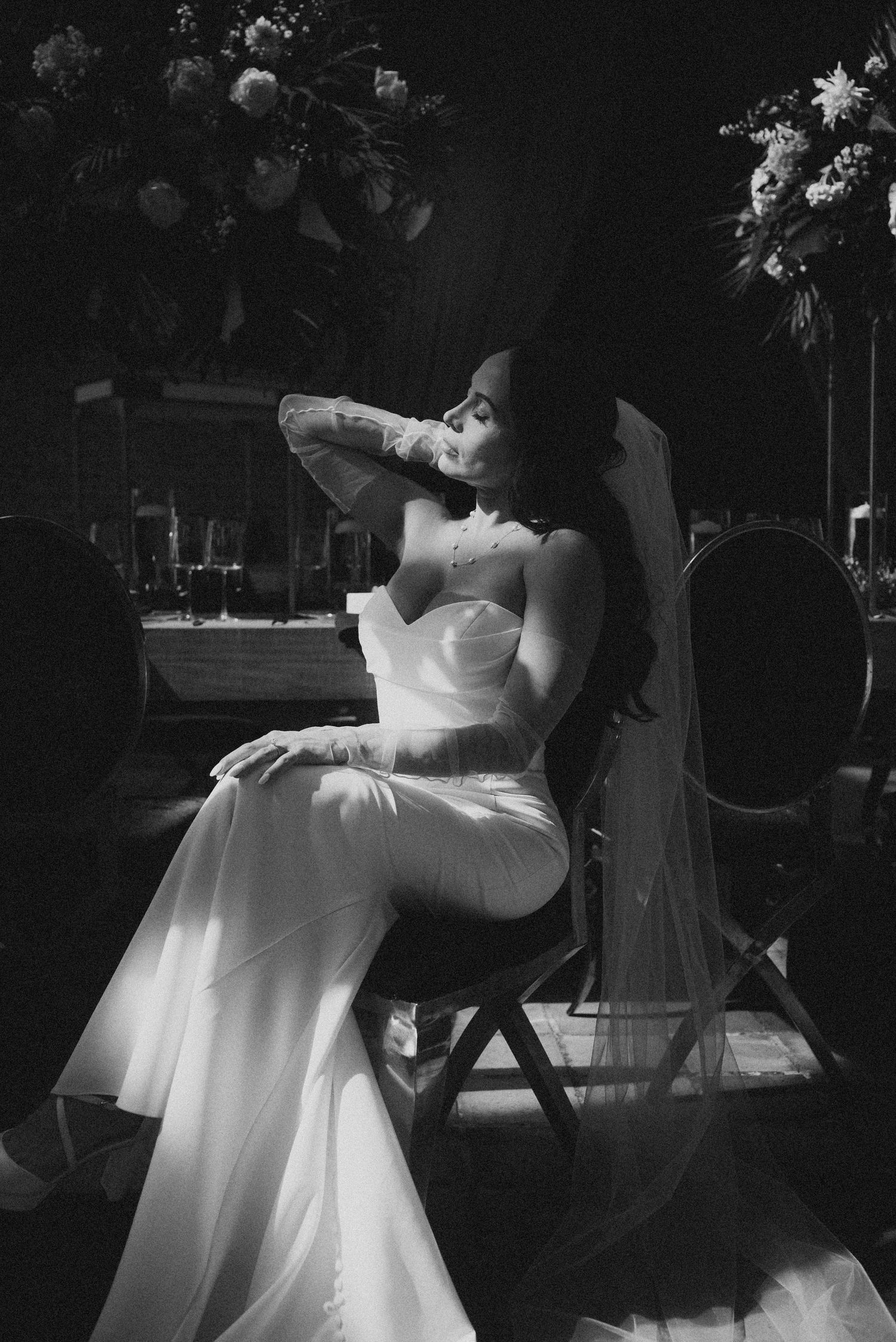 A romantic black and white wedding photo series showing a couple dancing and embracing in flowing white dress and veil.