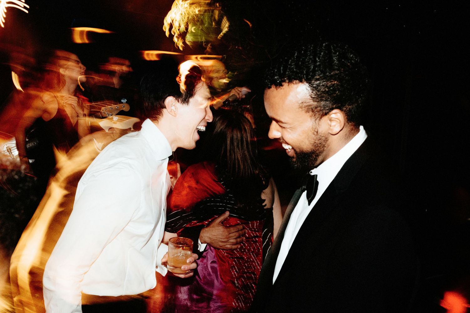 Candid dance floor moment captured in motion blur at an evening celebration.