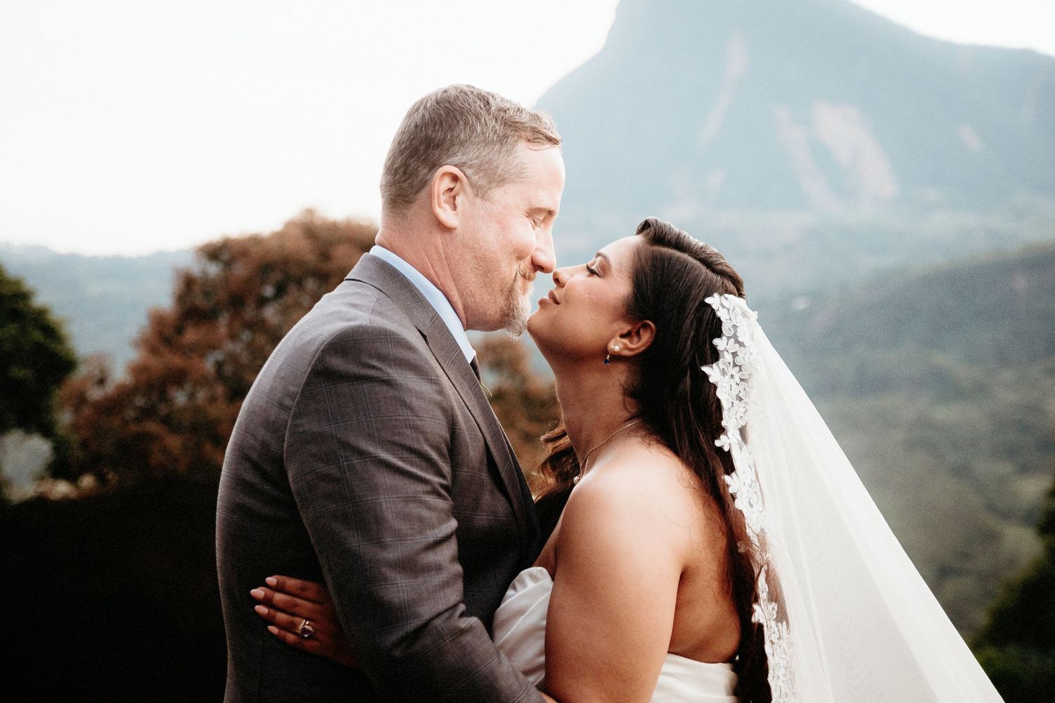 Intimate mountain wedding portrait with scenic backdrop.