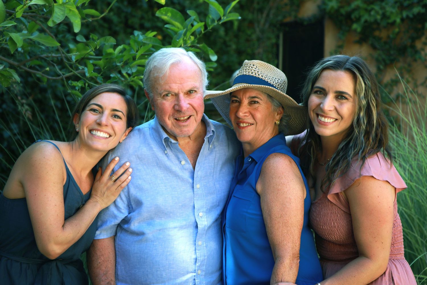 Mom and Dad with their girls with vines in background