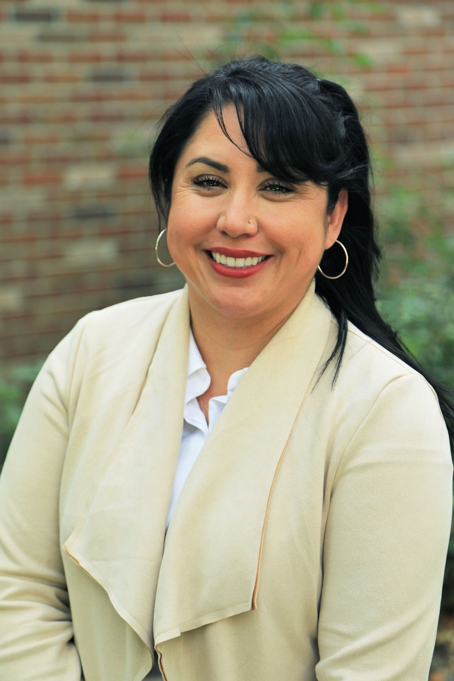 Headshot in front of brick building