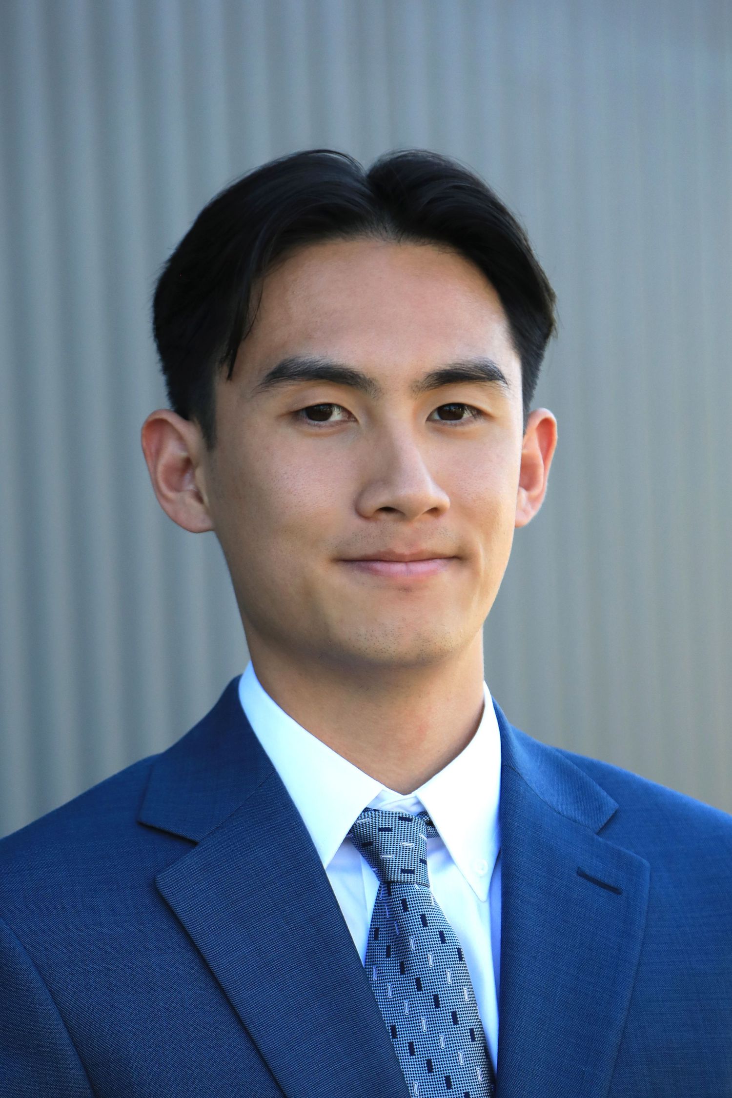 Headshots for Social Media page in front of gray background