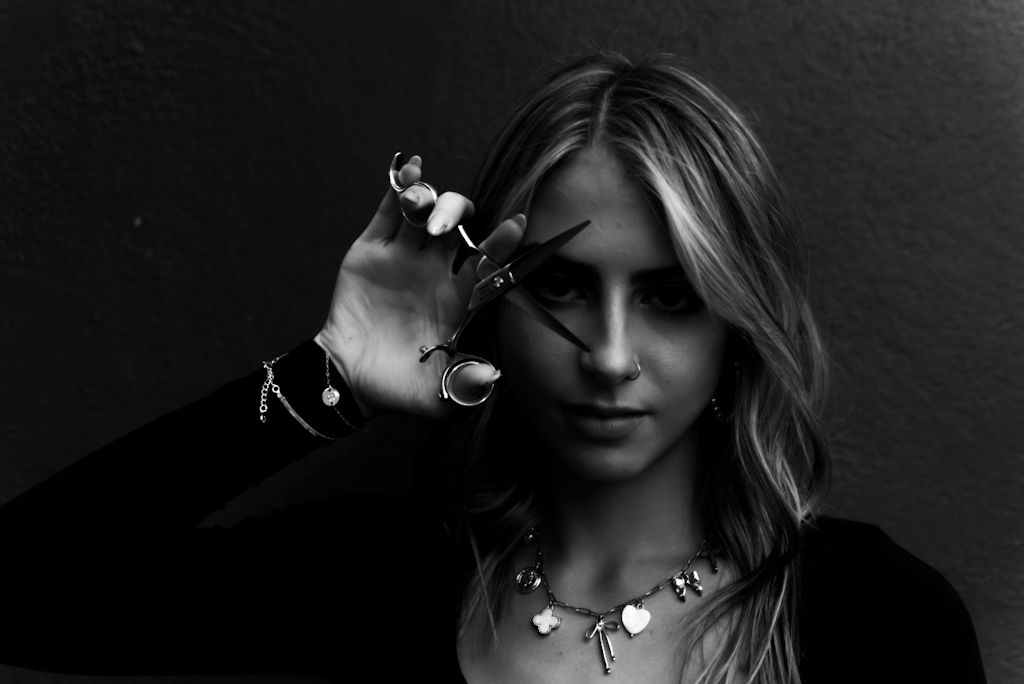 Black and white artistic portrait series showing dramatic lighting and shadows on figures wearing jewelry.
