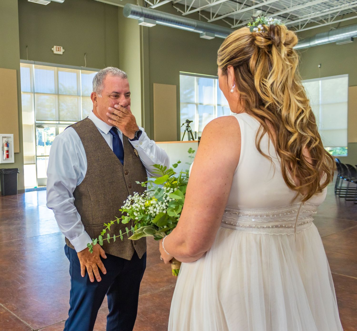 Emotional wedding moment captured in indoor venue.