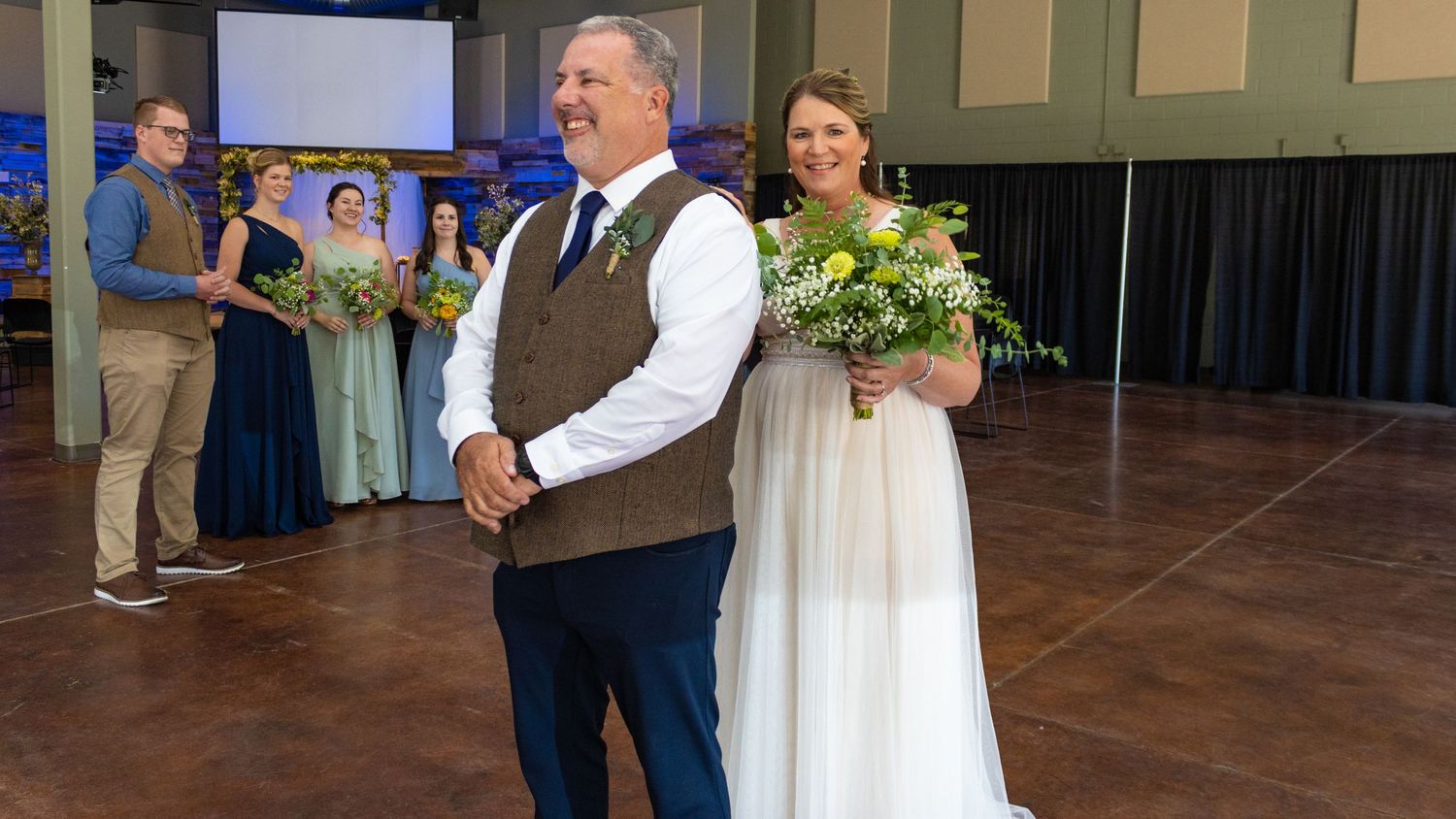 Wedding ceremony in indoor venue with couple celebrating.