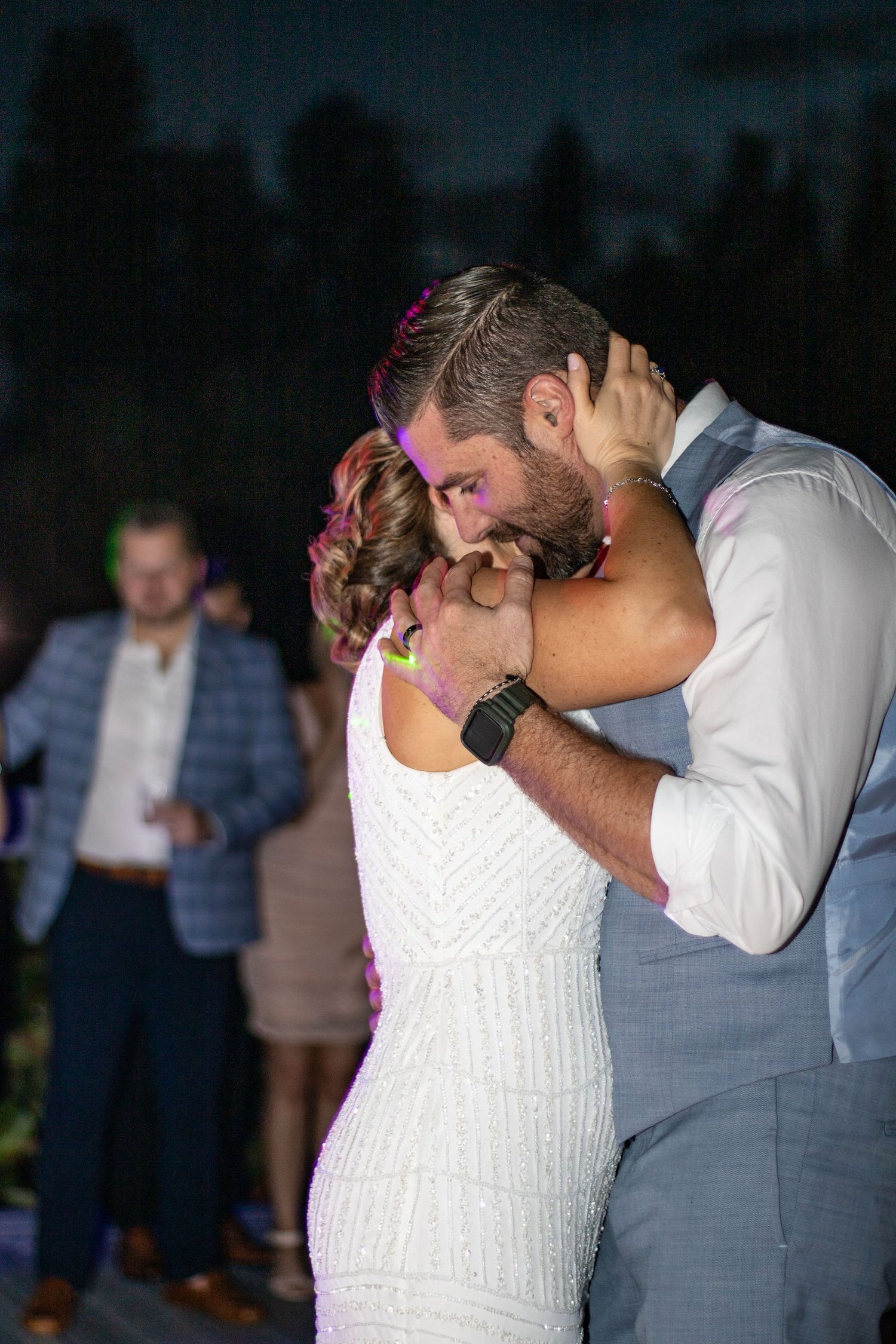 Newlyweds share an emotional dance moment at their evening reception.