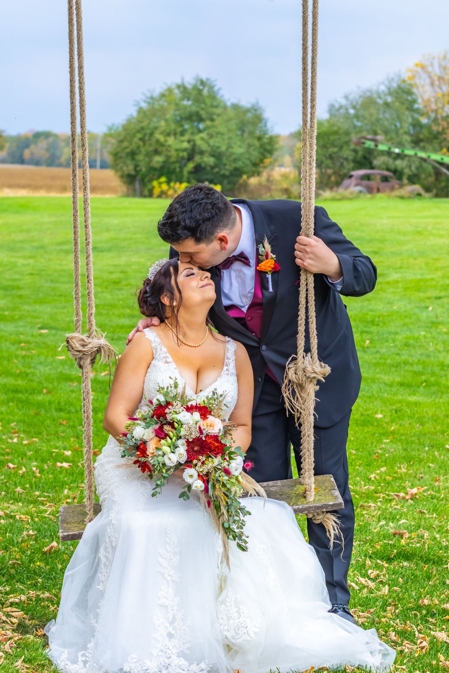 A romantic sequence of wedding photos showing a couple on a rustic wooden swing in a green field with wildflowers.