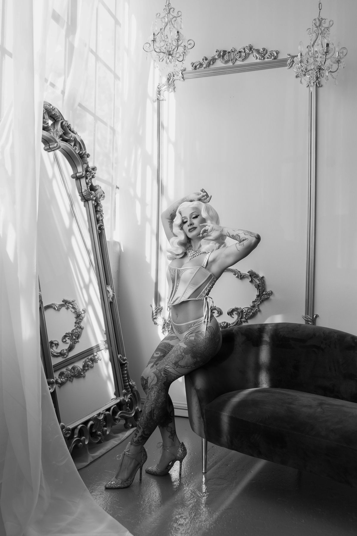 A black and white photo series shows a dancer in elegant poses against a wall with an ornate mirror and sconce.