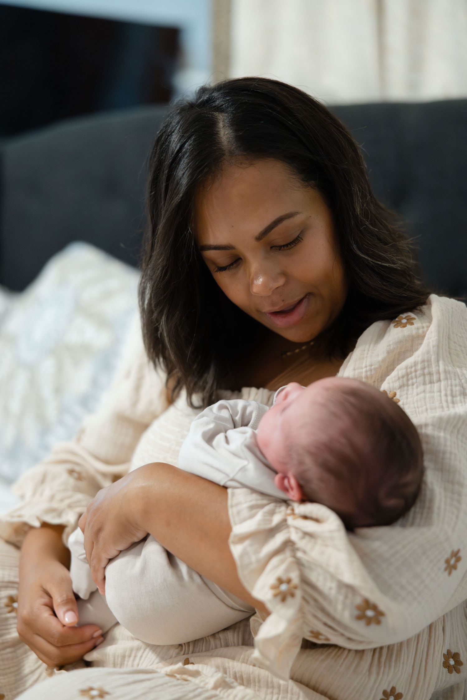 A mother in a white sweater lovingly cradles and bonds with her newborn baby in a series of tender moments.