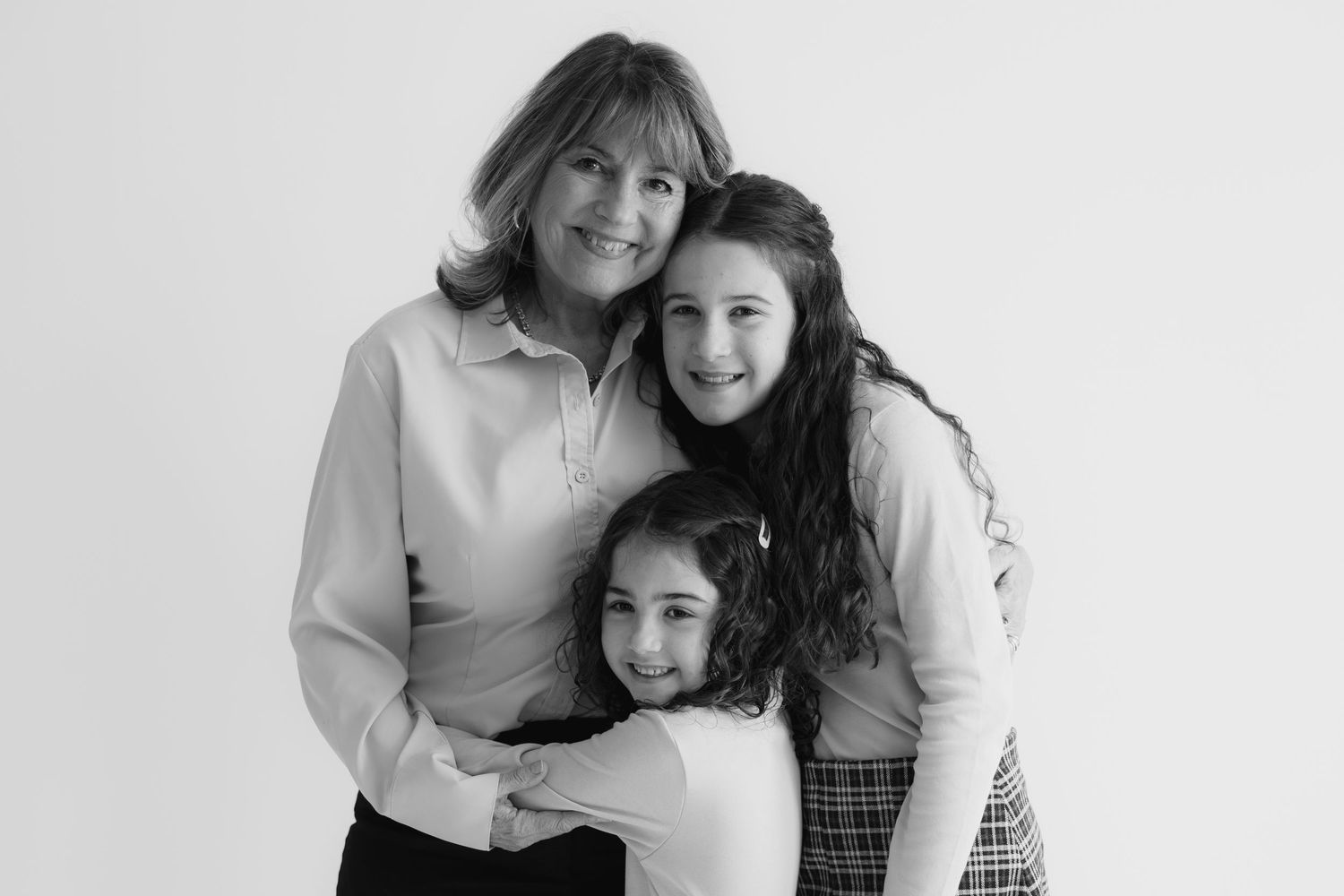 Black and white collage of natural portraits showing affection, smiles and laughter between loved ones.