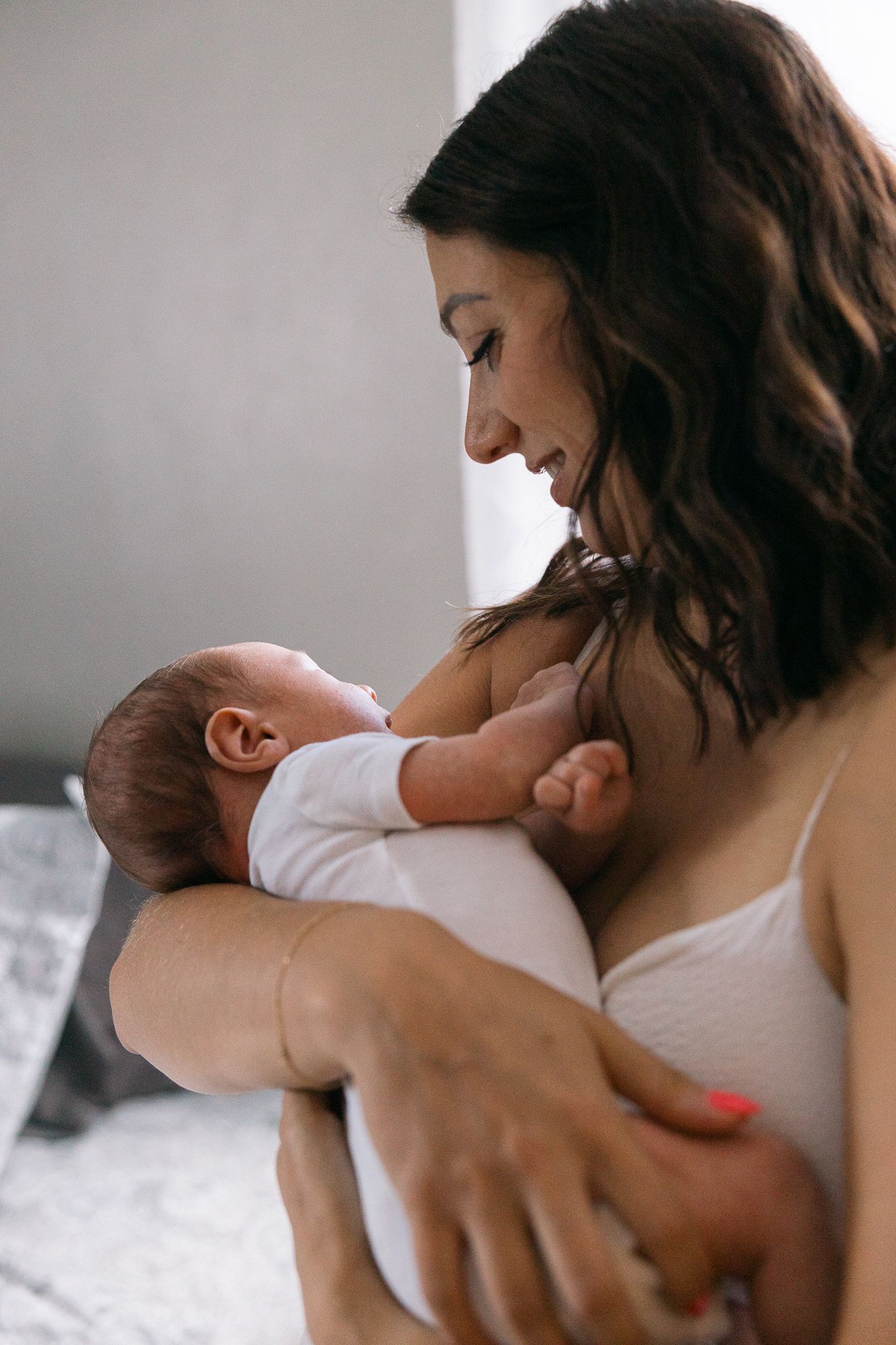 photo of new mom holding newborn baby in arms
