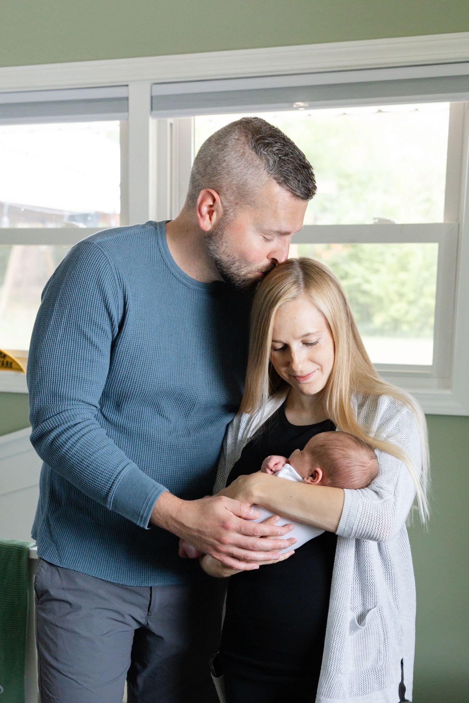 A tender family moment captured in a series of four intimate photographs showing parents with their newborn baby.