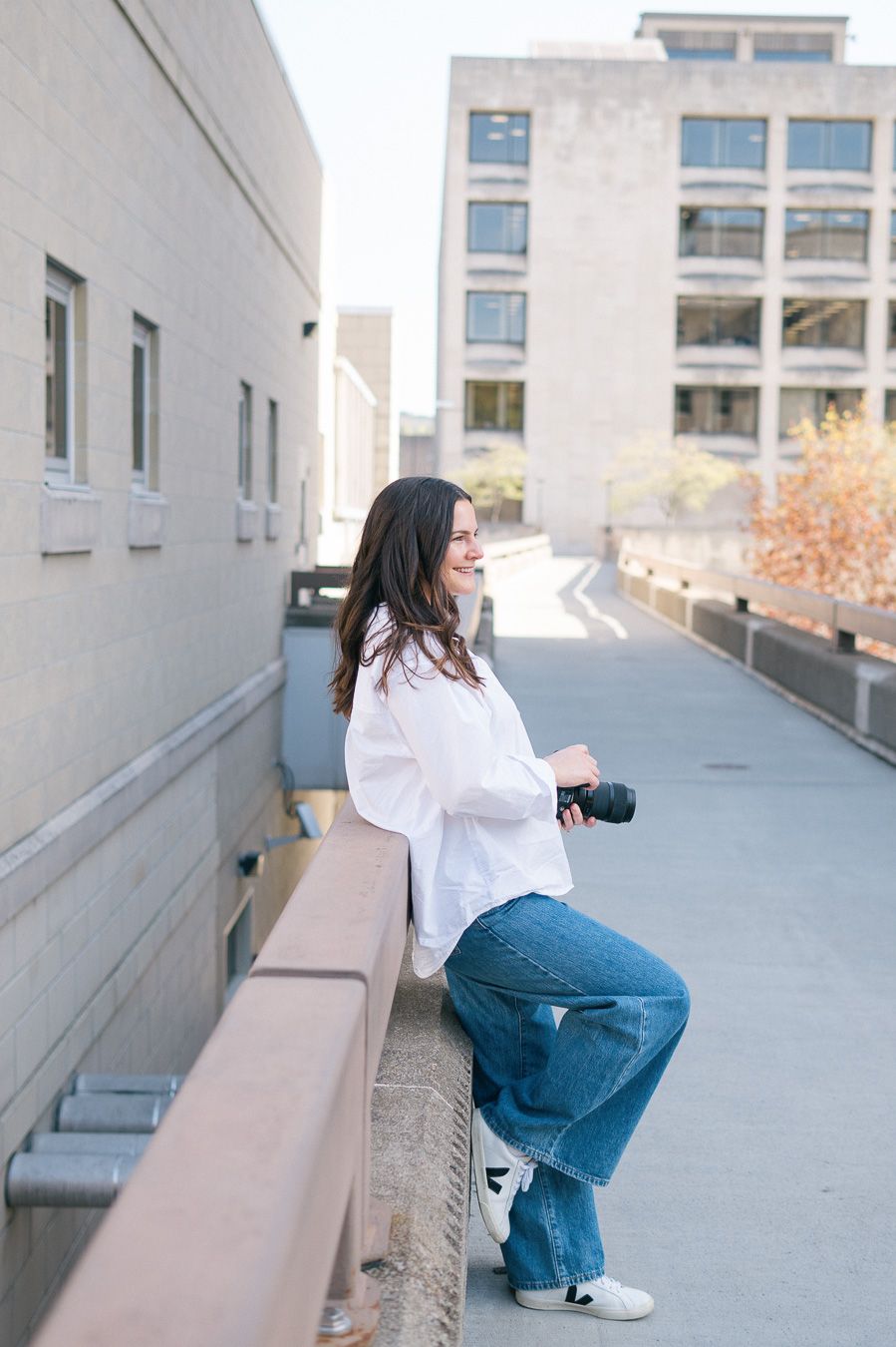 A person in blue jeans and white shirt poses on a concrete ledge in multiple creative angles.