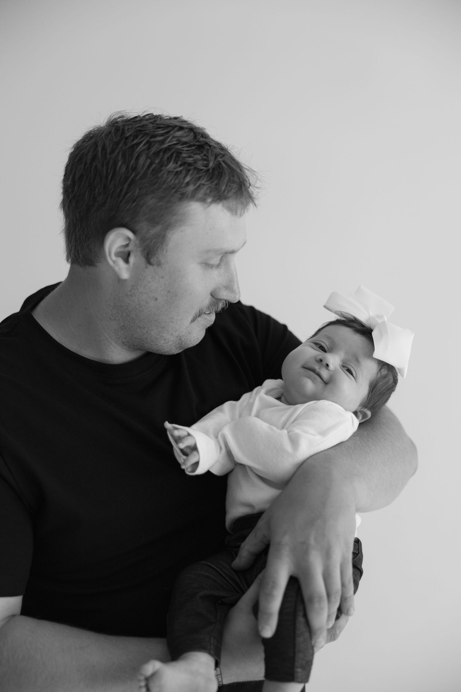 A series of black and white photos showing two figures in an intimate embrace against a white background.