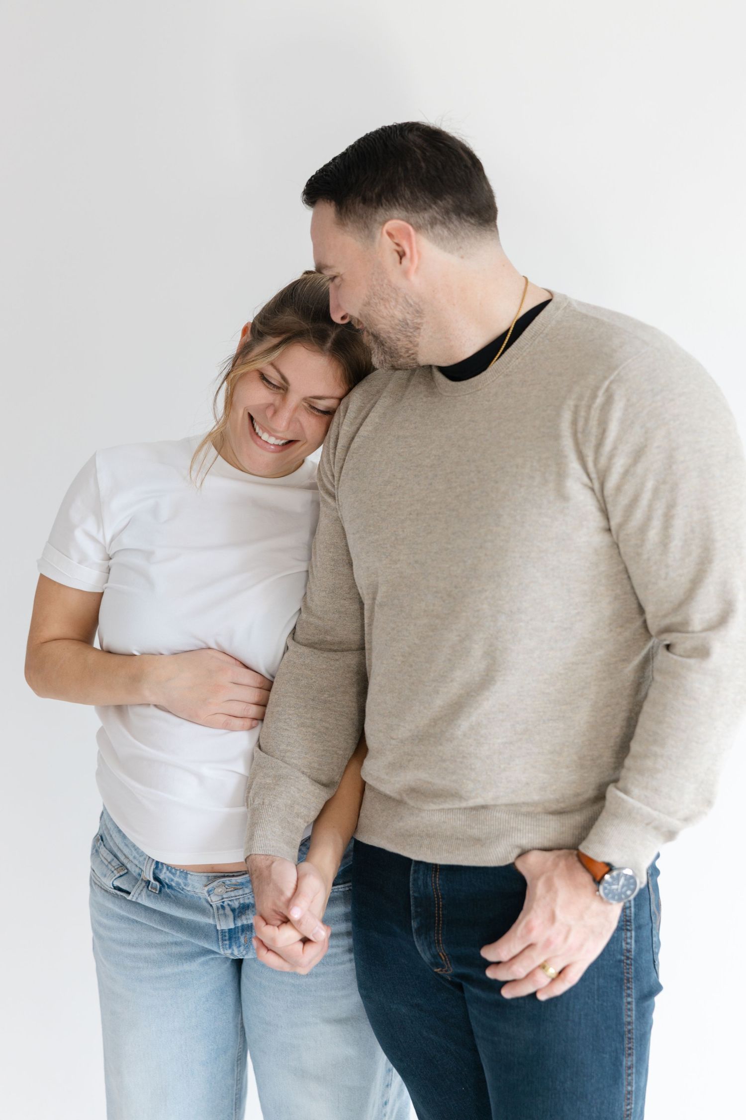 Couple in casual attire sharing an intimate moment against white background in three progressive poses.