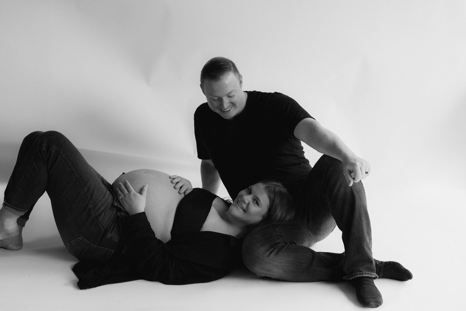 A series of black and white photos showing a figure in dark clothing lying down in different resting positions.