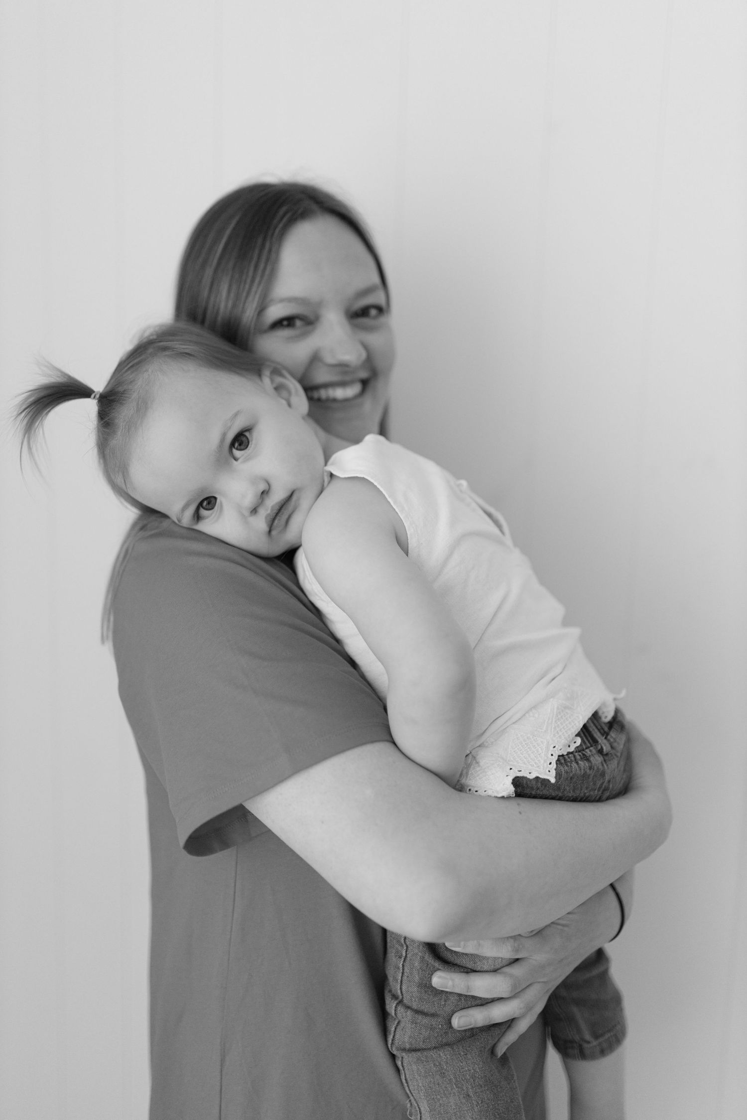 Black and white photo series showing a tender moment of embrace between a parent and child.