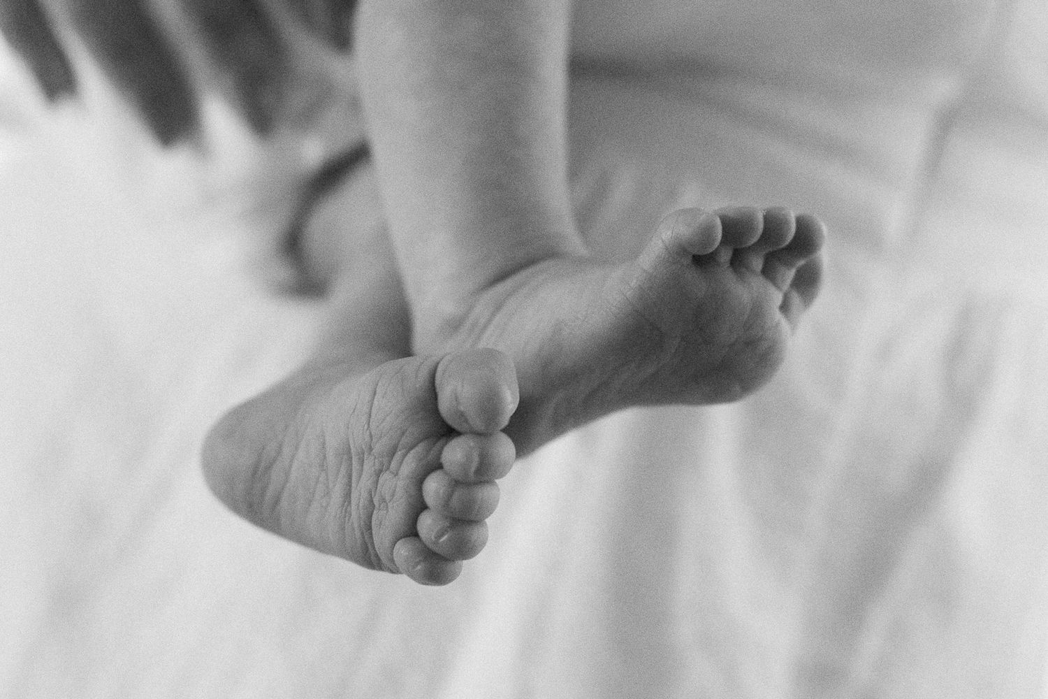 black and white photo of newborn baby feet