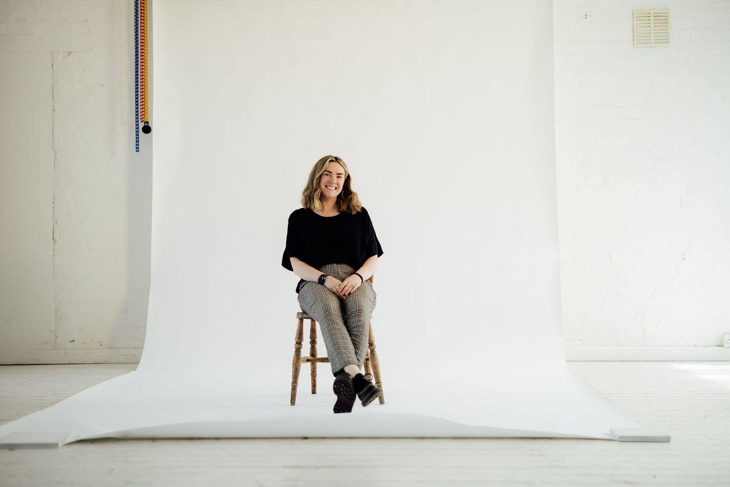 Studio image of photographer with her camera. Nottingham