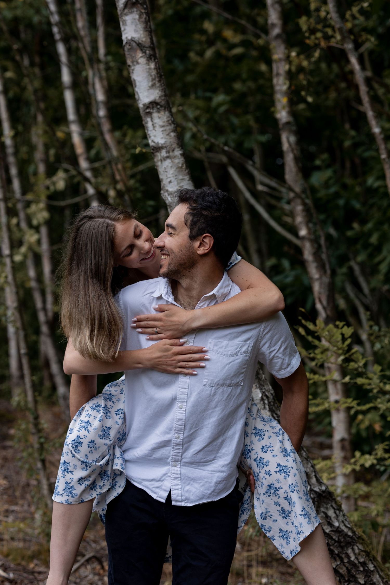 Piggy back! Couple looking at each other and smiling during a piggy back. Natural documentary wedding photography in Nottingham