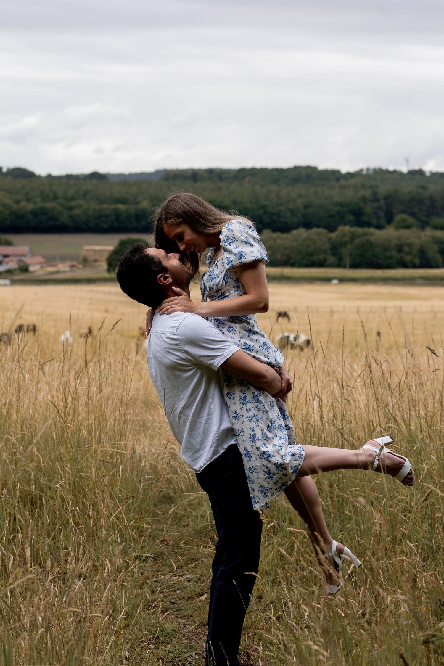 A romantic lift in the countryside during an engagement shoot. Natural documentary photography, Nottingham.