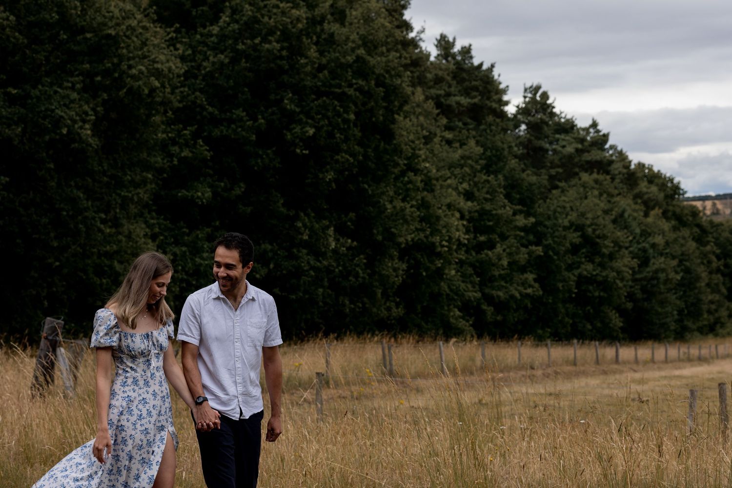 A couple walking and talking candidly during a couples session. Natural, documentary photography. Nottingham, Midlands.