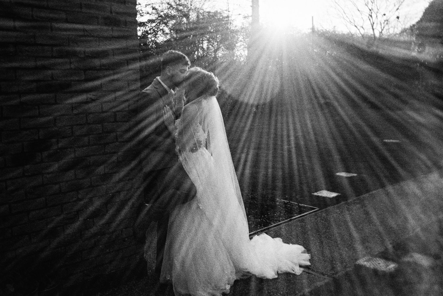 Beautiful golden hour and sun rays during couple portrait. Taken on 35mm Film in black and white at The Carriage Hall, Nottingham.