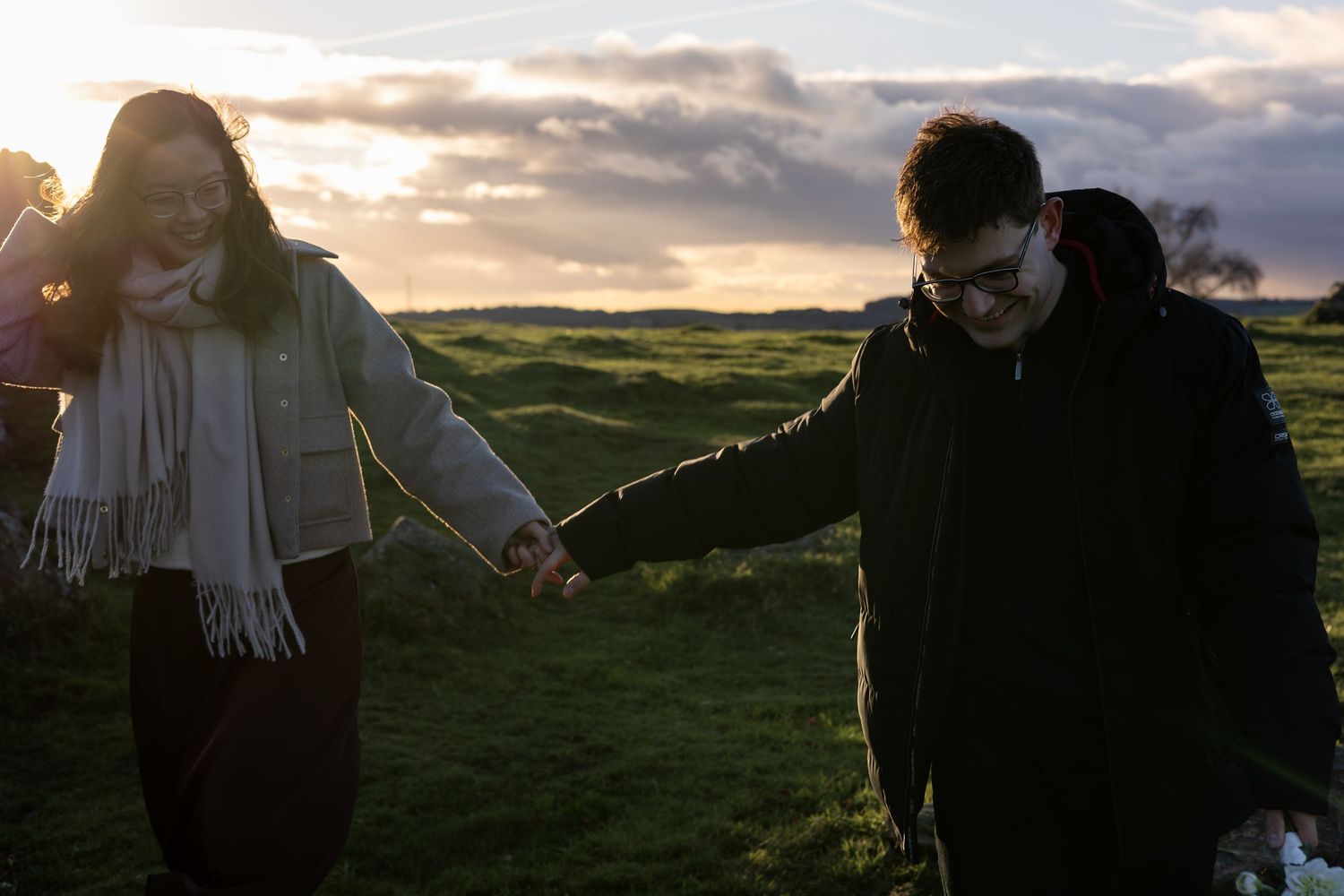 A couple during golden hour on their engagement shoot. Beautiful setting. Natural, documentary photography. Nottingham, Midlands.