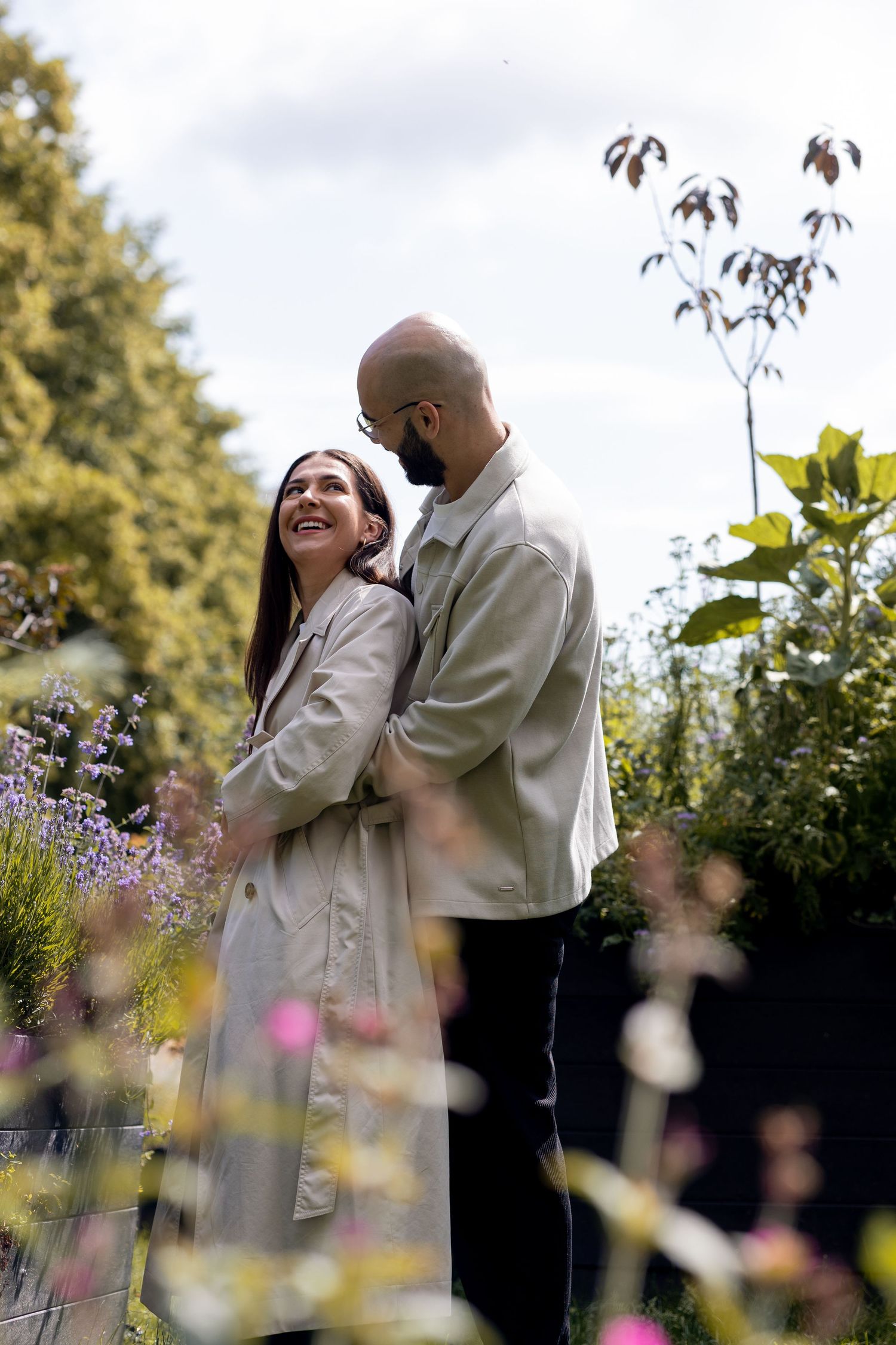 Couple looking at the flowers during their engagement shoot. Natural documentary photography