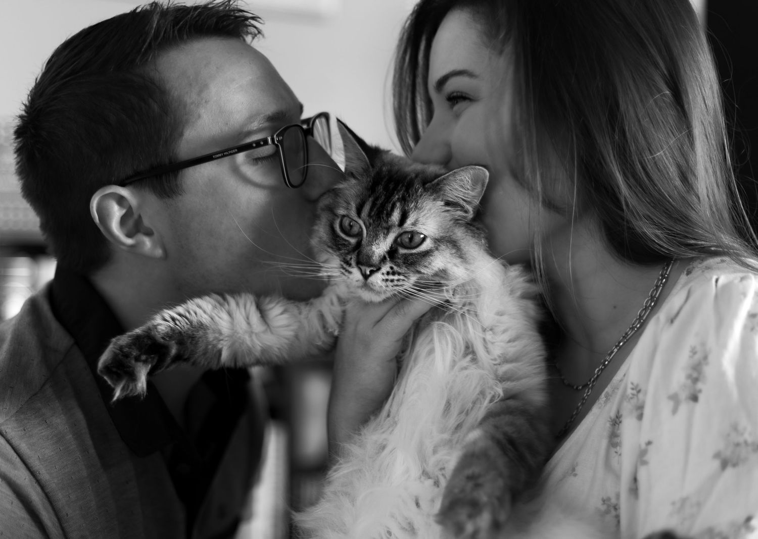 Couple with their fur baby cat! Both kissing the cat