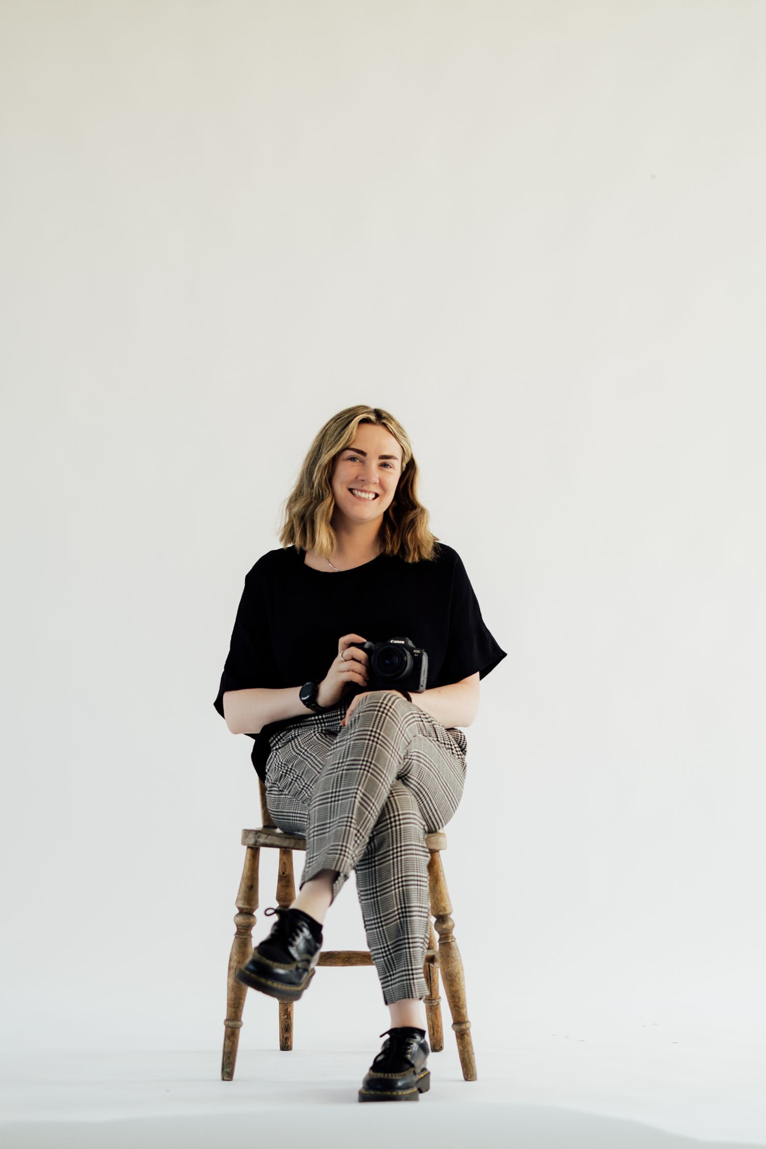 Studio image of photographer with her camera. Nottingham