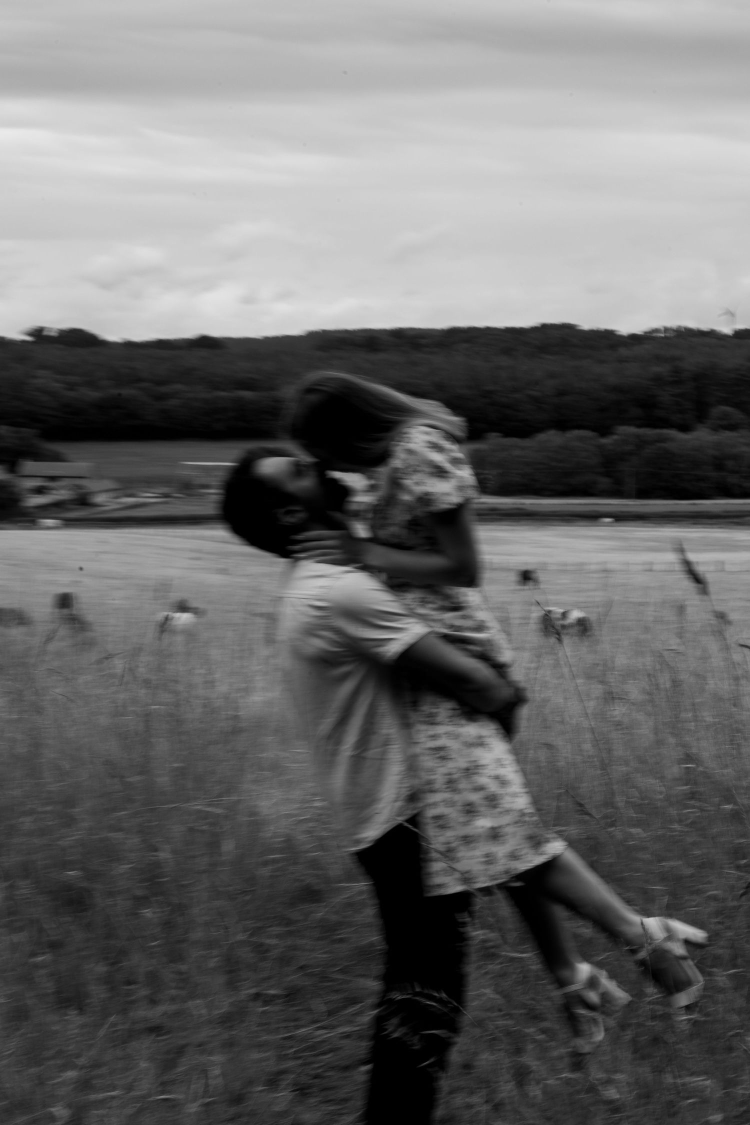 A romantic lift in the countryside during an engagement shoot. Natural documentary photography, Nottingham.