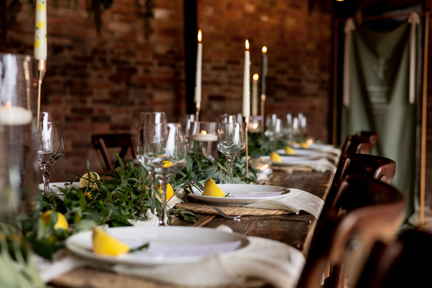 Stunning styling with tapered candles and foliage set up at The Fable Yard in the Midlands.