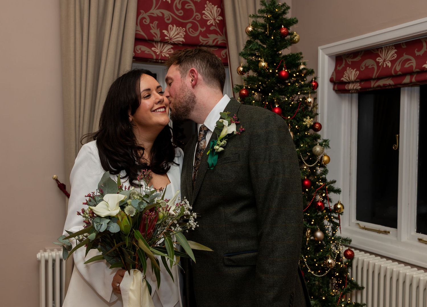 Bride and groom full of joy and romance at their twilight Christmas wedding at West Bridgford Registry Office