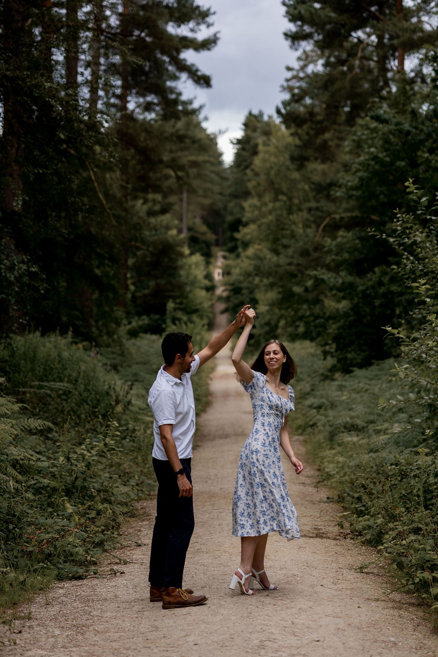 Couple dancing in the beautiful serene woods in Nottingham during their engagement shoot. Natural documentary photography.