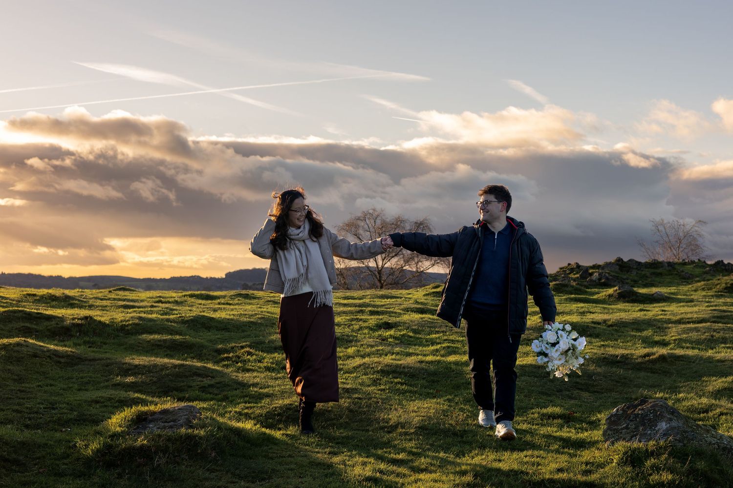 A couple during golden hour on their engagement shoot. Beautiful setting. Natural, documentary photography. Nottingham, Midlands.