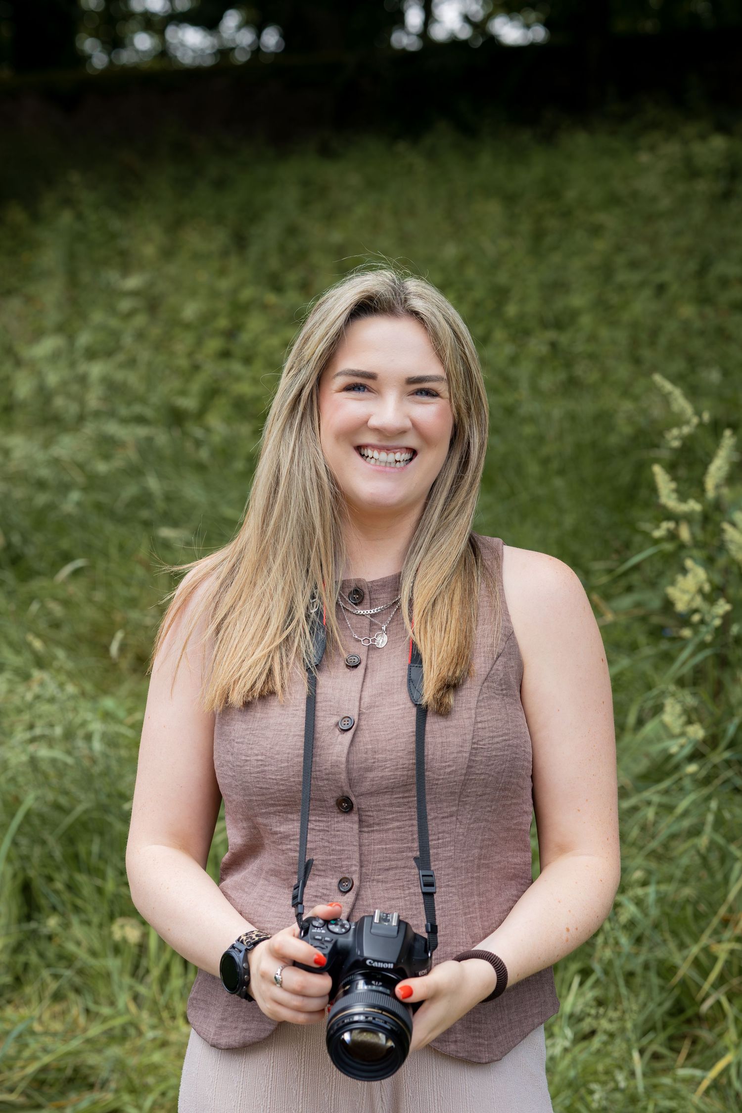 A headshot of the photographer and her camera