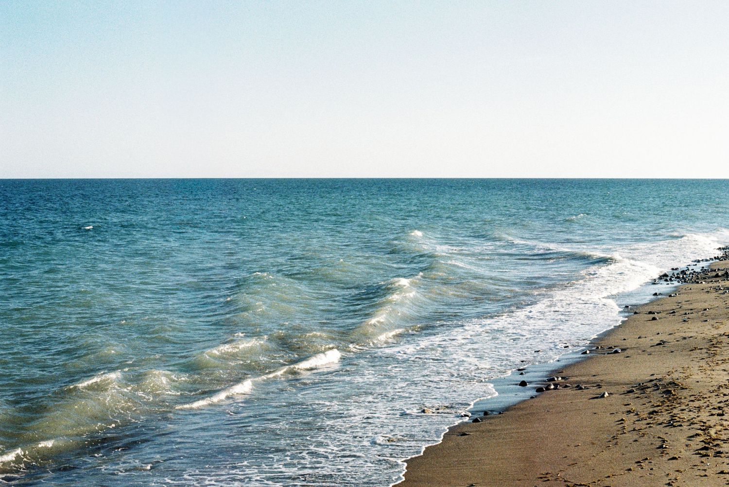 The sea and sand taken on 35mm film. Documentary style photography. Film photography.