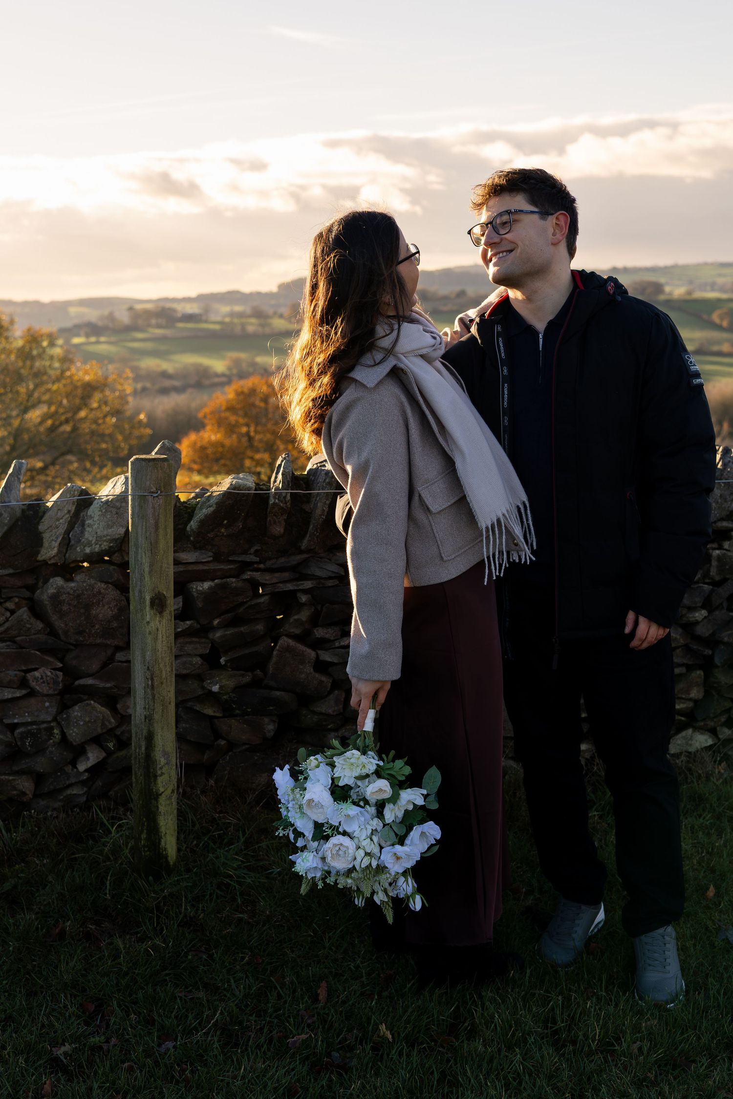 A couple during golden hour on their engagement shoot. Beautiful setting. Natural, documentary photography. Nottingham, Midlands.