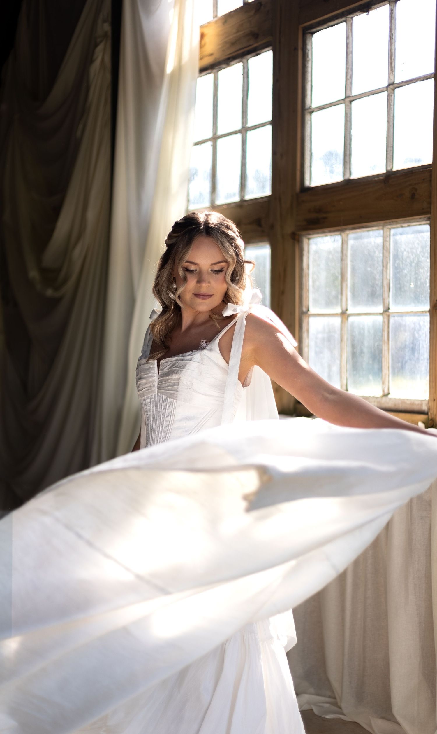Beautiful bride in golden hour spinning her dress around. Golden hour. joy. Natural documentary wedding photography