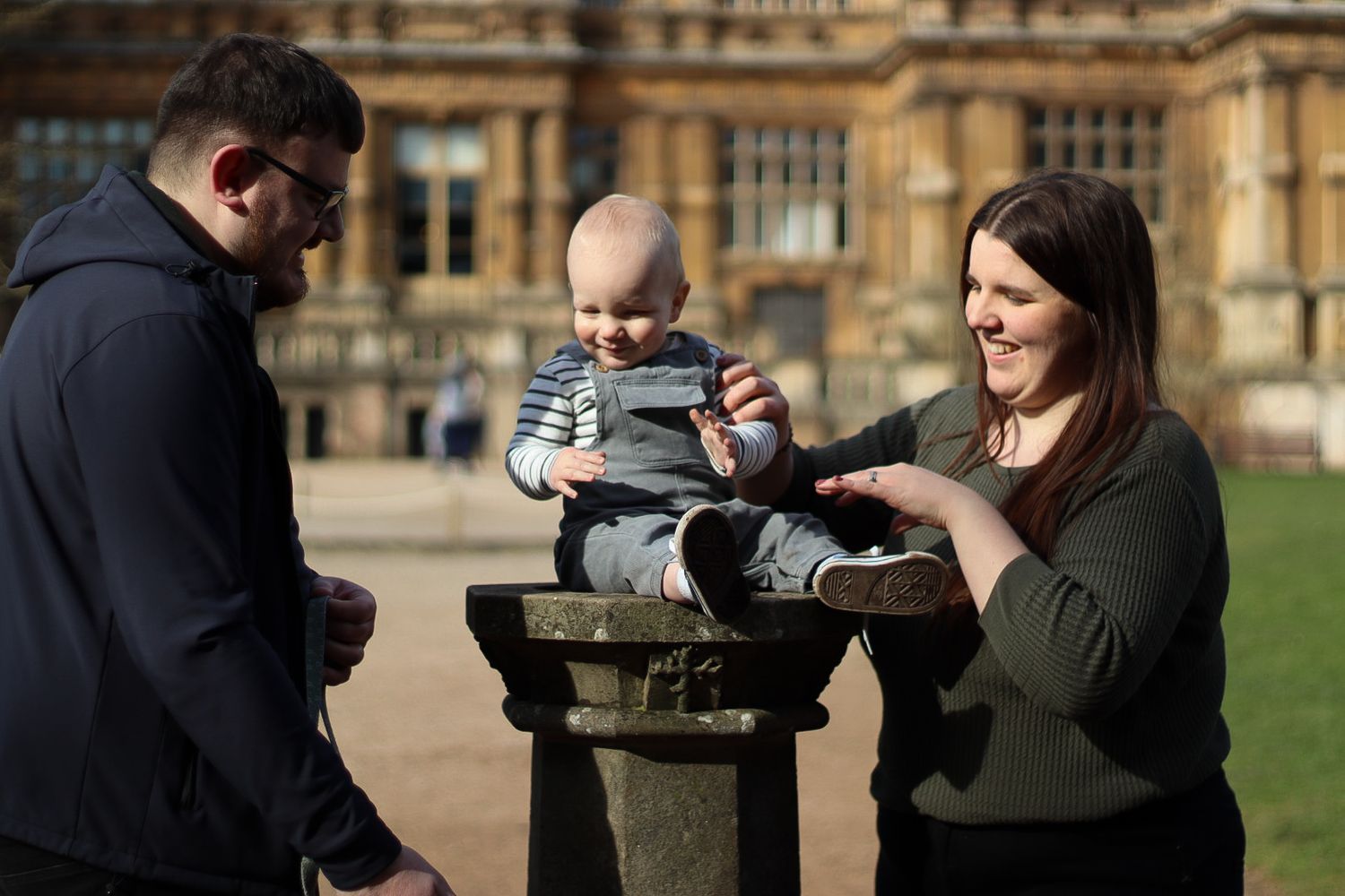 Mum, dad and baby laughing candidly. Natural documentary photography